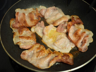 Cooked sizzling hot tasty crispy bacon ready for breakfast overhead shotTasty greasy fried bacon slices close up
