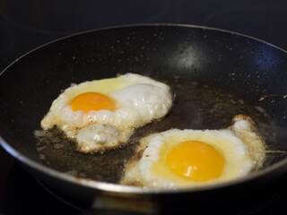 Scrambled eggs on frying pan