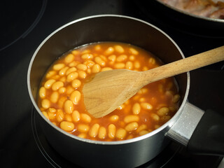 Bubbly hot baked beans (brown sugar recipe) right out of the oven. Closeup with shallow dof.