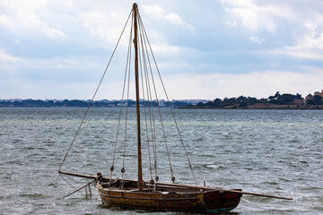traditional mediterranean wooden sailboat anchored without sails mounted