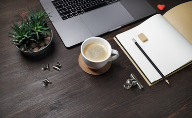 Office supplies and laptop on wooden background. Online business concept.