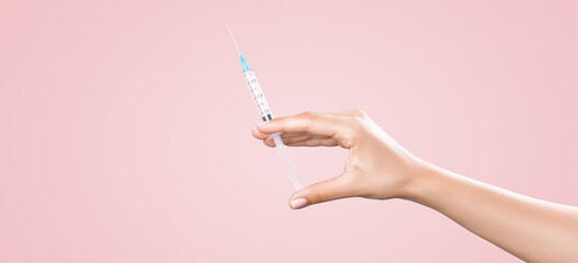 Hand holding syringe with vaccine against corona virus.