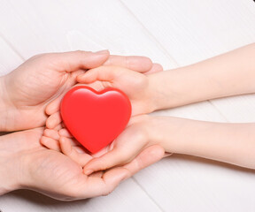 Man give red heart to kid as couple. Healthcare and hospital medical concept. Donation concept.Symbolic of Valentine day.Top view with space for text.