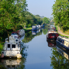 Fototapeta na wymiar Canal boats narrowboats moored on Leeds-Liverpool canal at Parbold in Lancashire, England