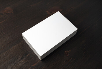 Blank white box mockup on wooden background.