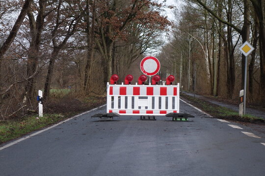 Closed road with a roadblock and traffic signs