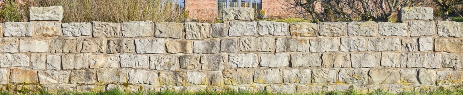 Rustic Rough Garden Wall Made Of Sandstone Blocks.