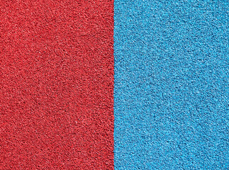 Top view of sports ground or running track texture with red and blue colored halves