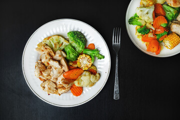 Grilled chicken breast fillet with roasted vegetables. Concept healthy food. Flat lay.