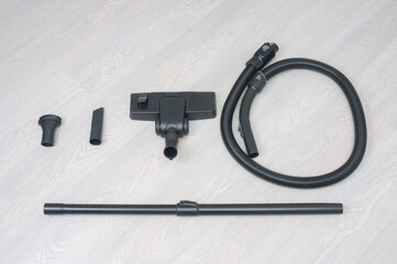 Nozzles for vacuum cleaner on a wooden floor background