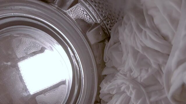 White laundry being washed in the washing machine