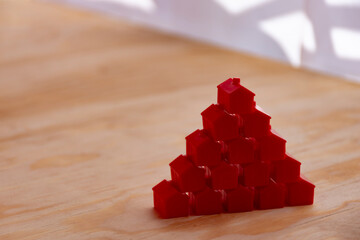 Pyramid of red houses. Real estate concept, high economy.