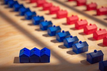 Three blue houses in front of a line of blue and red houses. Home purchase concept. Concept for real estate industry.