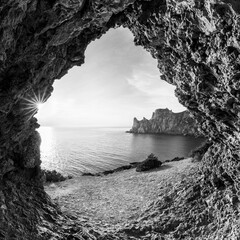 Inside a cave. View to the sea shore from a cave entrance