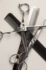 scissors and comb on a white background. knife on a wooden surface