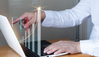 Businessman use laptop ,analytics and financial and bank technology concept, chart from computer laptop,Business growth concept. business finance technology and investment concept. Stock Market 