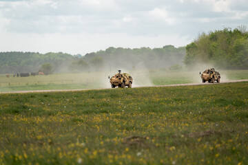 two Supacat Jackal army rapid assault, fire support and reconnaissance vehicles in action on a...