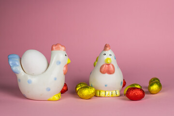 two chickens and chocolate eggs background for Easter