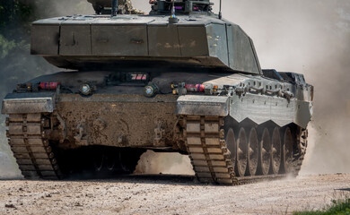 British army Challenger 2 FV4034 battle tank in motion with clouds of dust on a military exercise Wiltshire UK