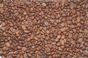 Light roasted coffee beans in soft light as background
