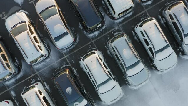 Aerial top down view of the car park of a car dealership or customs terminal with rows of new SUVs (crossovers)