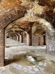 Fort Jefferson at Dry Tortugas National Park in the Florida Keys. Aging brick fort. Rainwater leaches calcium carbonate from the mortar, slowly depositing stalactites and stalagmites in the arches. - obrazy, fototapety, plakaty
