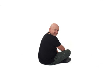  view of man sitting on floor looking at camera on white backgound