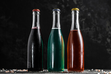 Low alcohol drink bottles with drops, chilled colorful beverages. summer party