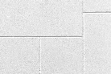 Fototapeta premium The walls of the cement building are painted white with a rough surface