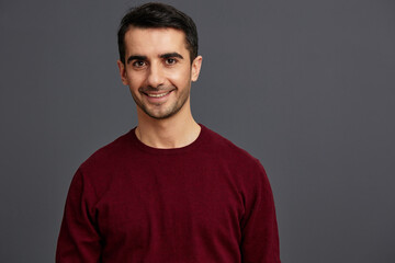 Fototapeta premium handsome man in a red sweater hand gesture posing self confidence cropped view