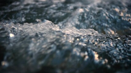 Slow motion of Norwegian mountain river , stream flowing through rocks. Close up of river stones with flowing water, clean water flowing in a mountain river at the Norway - Powered by Adobe