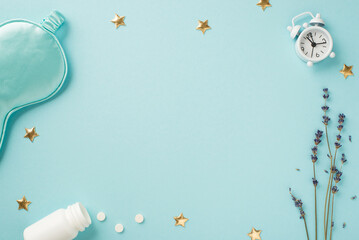 Top view photo of sprig of lavender small white alarm clock blue silk sleeping mask open bottle with pills and golden stars on isolated pastel blue background with empty space in the middle