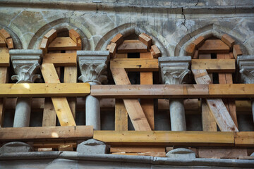 Conservation and restoration of cultural heritage concept. Wooden props  supporting dilapidated...