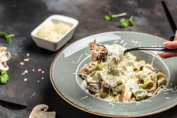 Pasta fettuccine with mushrooms and fried chicken ham in creamy cheese sauce. Tagliatelle pasta. Traditional Italian cuisine. banner, menu, recipe place for text, top view