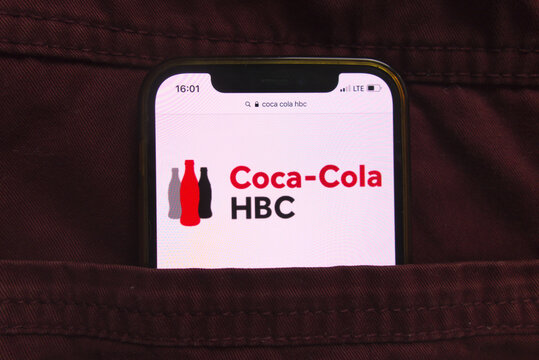 KONSKIE, POLAND - February 18, 2022: Coca Cola HBC company logo on mobile phone hidden in jeans pocket