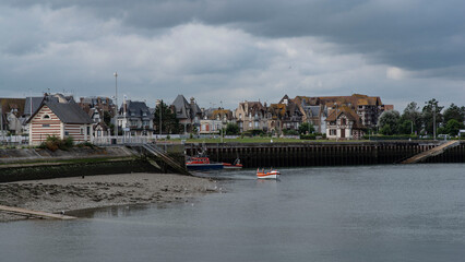 Typical Normandy house and boats in the port of Trouville in Normandy, France
