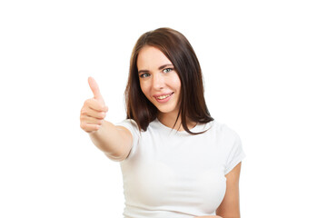 Cute girl with brown hair in a white T-shirt shows a thumbs up gesture.