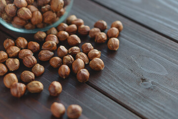 Close up brown hazel nut on wooden desk. Healthy organic snack hazelnut. Vegetarian nutrition.