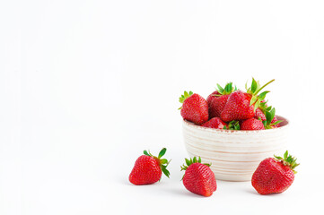 Fresh strawberries in ceramic bowl on white background