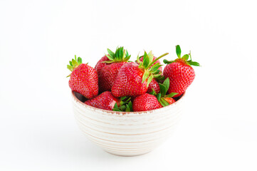 Fresh strawberries in ceramic bowl on white background