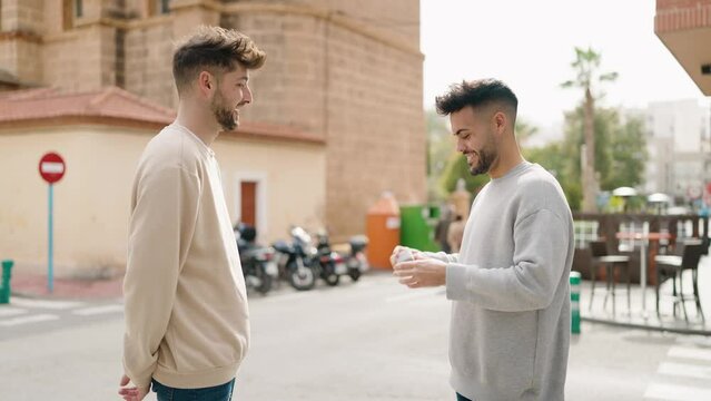 Young couple smiling confident having engagement proposal at street