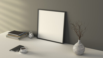Square black picture poster frame mock up. Cup of coffee, books, vase and notebook on white table. Gray wall background.