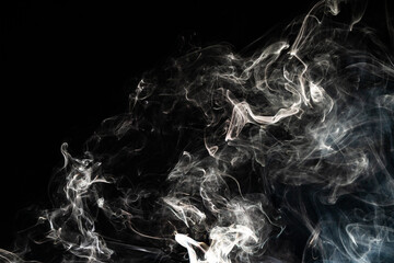 Smoke effect texture. Isolated background. Black and dark backdrop. Smokey fire and mistic effect.