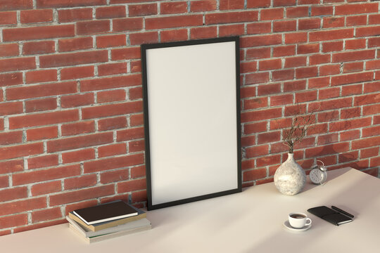 Vertical black picture poster frame mock up. Cup of coffee, books, vase and notebook on white table. Red brick wall background.