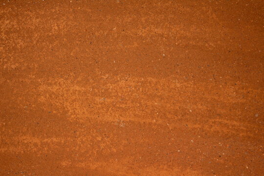 Saibro do ch&atilde;o da quadra de t&ecirc;nis. Saibro alaranjado. solo da quadra de t&ecirc;nis. para jogar t&ecirc;nis. Textura de saibro. Fundo de saibro.