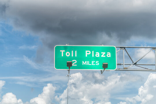 Sign For Toll Plaza In 2 Miles Lane For I75 Interstate Highway From Miami To Naples In Florida And Clouds In Blue Sky