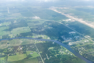 High angle aerial view of Ft Myers countryside landscape with farm fields Caloosahatchee river and...