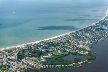 Tuinposter High angle aerial view of Ft Myers beach landscape near Sanibel Island in southwest in Florida Saharan with beautiful green water and houses buildings © Kristina Blokhin