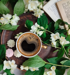 Cup of coffee and spring jasmine flowers