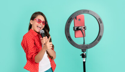 cheerful kid music blogger. karaoke. child singing song. vlogger with microphone.